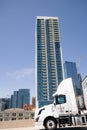 Simple skyscraper portrait from street view with truck in foreground