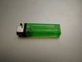 Close up of simple small green gas lighter Royalty Free Stock Photo