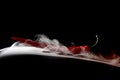 Simple smoke on black background with red hot pepper Royalty Free Stock Photo