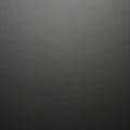 A simple, solid black textured background. The surface appears smooth, with subtle Royalty Free Stock Photo
