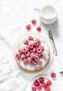 Simple sponge cake with powdered sugar and fresh raspberries on a light background. Summer berry dessert. Royalty Free Stock Photo
