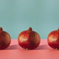 Simple square composition with row of pomegranates on two coloured background