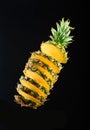 Still-life. large sliced pineapple on a black background