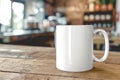 A simple still life scene featuring a white coffee mug placed on a wooden table Royalty Free Stock Photo