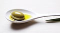 simple still life with spoon filled with olive oil and olives and leaves from olive tree as decortation