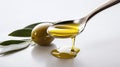 simple still life with spoon filled with olive oil and olives and leaves from olive tree as decortation