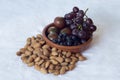 Simple still life on vintage canvas with tomatoes, blueberries, and black grapealmonds. s Royalty Free Stock Photo