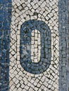 Simple stone flooring with zero sign in Elvas, Portugal, Europe. Abstract background, vertical photo Royalty Free Stock Photo