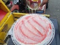 a simple street food in Indonesia made from flour topped with strawberry jam and milk