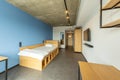 Simple student-style dorm bedroom. Hostel dormitory room. Campus