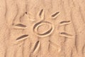 Simple sun drawing in the sand on The beach. Summer travel concept Royalty Free Stock Photo