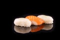 Simple sushi nigiri maki set isolated on black background. Various selection of traditional japanese Royalty Free Stock Photo