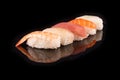Simple sushi nigiri maki set isolated on black background. Various selection of traditional japanese Royalty Free Stock Photo