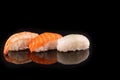 Simple sushi nigiri maki set isolated on black background. Various selection of traditional japanese Royalty Free Stock Photo