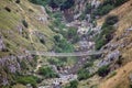 Simple suspension bridge on the canyon carved by the Gravina River where lies Matera, Basilicata, Italy Royalty Free Stock Photo