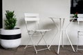 Simple table and chairs against wall Royalty Free Stock Photo