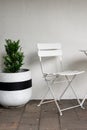 Simple table and chairs against wall Royalty Free Stock Photo