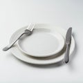 A simple table setting features a small white plate placed on a larger one, both with a Royalty Free Stock Photo