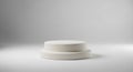 Simple two-step white cylindrical display podium on a clean white surface with soft studio lighting Royalty Free Stock Photo