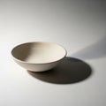 A simple, unadorned, light-colored ceramic bowl Royalty Free Stock Photo