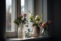 simple vase of flowers and indoor plants on the windowsill