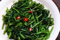 Simple vegan food for vegetarian meal, water spinach fry with cooking oil Royalty Free Stock Photo