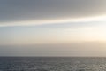 Peaceful and simple view over Mediterranean sea water with rocks and horizon at the end of the day