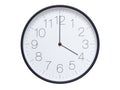 Simple wall clock with black frame and white face displaying 04:00 or 16:00. Royalty Free Stock Photo
