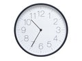 Simple wall clock with black frame and white face displaying 10:35 or 22:35. Royalty Free Stock Photo