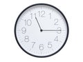 Simple wall clock with black frame and white face displaying 11:15 or 23:15. Royalty Free Stock Photo