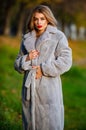 Simple and warm. Sexy woman red lips wear fur coat. Businesswoman in fur coat. Glamorous lady. Cosy autumn outfit Royalty Free Stock Photo