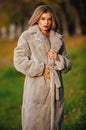 Simple and warm. Sexy woman red lips wear fur coat. Businesswoman in fur coat. Glamorous lady. Cosy autumn outfit Royalty Free Stock Photo