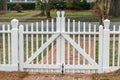 Simple white Americana white fence and closed gate