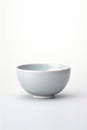 A simple white bowl placed on a table. Ideal for food or kitchen concepts Royalty Free Stock Photo