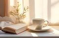 simple white breakfast cup with open book, book and white saucer,