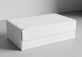 A simple white cardboard box with a lid sitting on a light gray surface Royalty Free Stock Photo