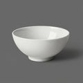 A simple, white ceramic bowl displayed against a plain gray background. The bowl Royalty Free Stock Photo