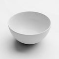 Simple White Ceramic Bowl on a Light Gray Background with Subtle Shadow empty clean Royalty Free Stock Photo