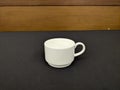 Simple White Ceramic Cup on a Dark Table Royalty Free Stock Photo