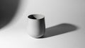 White ceramic cup on a gray background with shadow Royalty Free Stock Photo
