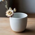 A simple white ceramic cup sits Royalty Free Stock Photo