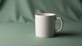 A simple white ceramic mug with a handle stands on a green fabric Royalty Free Stock Photo