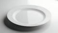Simple white ceramic plate casting shadow on a light surface Royalty Free Stock Photo
