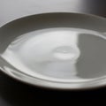 A simple white ceramic plate on Royalty Free Stock Photo