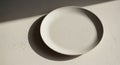A simple white ceramic plate is Royalty Free Stock Photo
