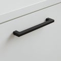 A simple white drawer with a sleek, black metal handle. The handle has a straight, Royalty Free Stock Photo