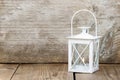 Simple white lantern on wooden background