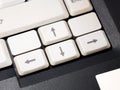 Simple white laptop arrow keys computer keyboard detail, macro, extreme closeup, nobody. Directions control, directional controls Royalty Free Stock Photo