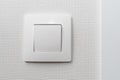 Simple white light switch, turn on or turn off the lights hanging on the white wall in the room Royalty Free Stock Photo