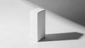 Simple white rectangular box casting a long shadow on a white surface object product Royalty Free Stock Photo